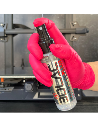 3DLAC PLUS 100 ml held in the hand in front of a 3D printer